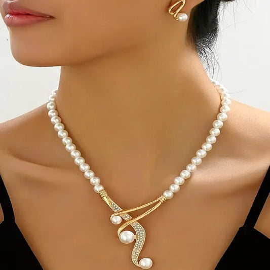 Pearl necklace with a gold clasp on a model against a neutral background