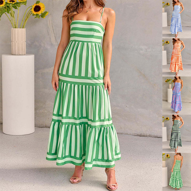 Green and white striped dress worn by a model against a neutral background