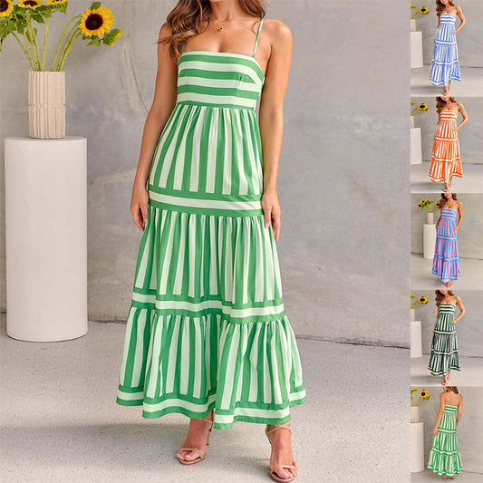 Green and white striped dress worn by a model against a neutral background