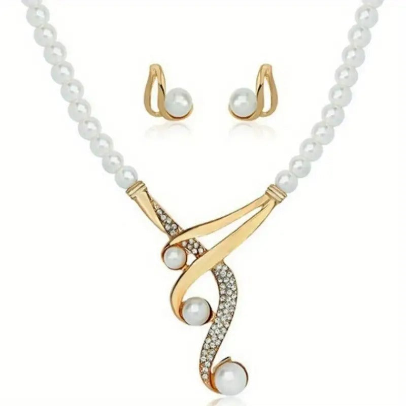 Gold necklace and earrings with pearls on a white background