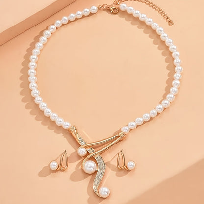 Pearl necklace with gold clasp and matching earrings on a beige background